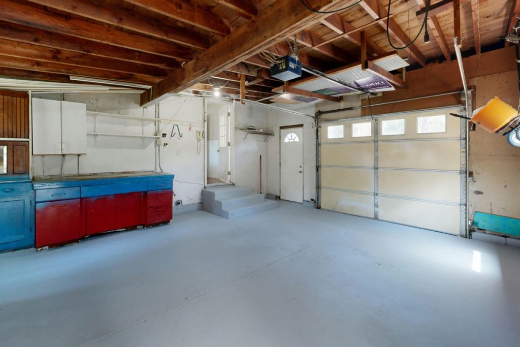 Settled garage floor stabilized with polyurethane concrete lifting