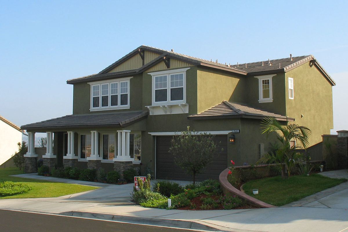 Suburban home with clean driveway and attached garage for KC MudJack concrete lifting