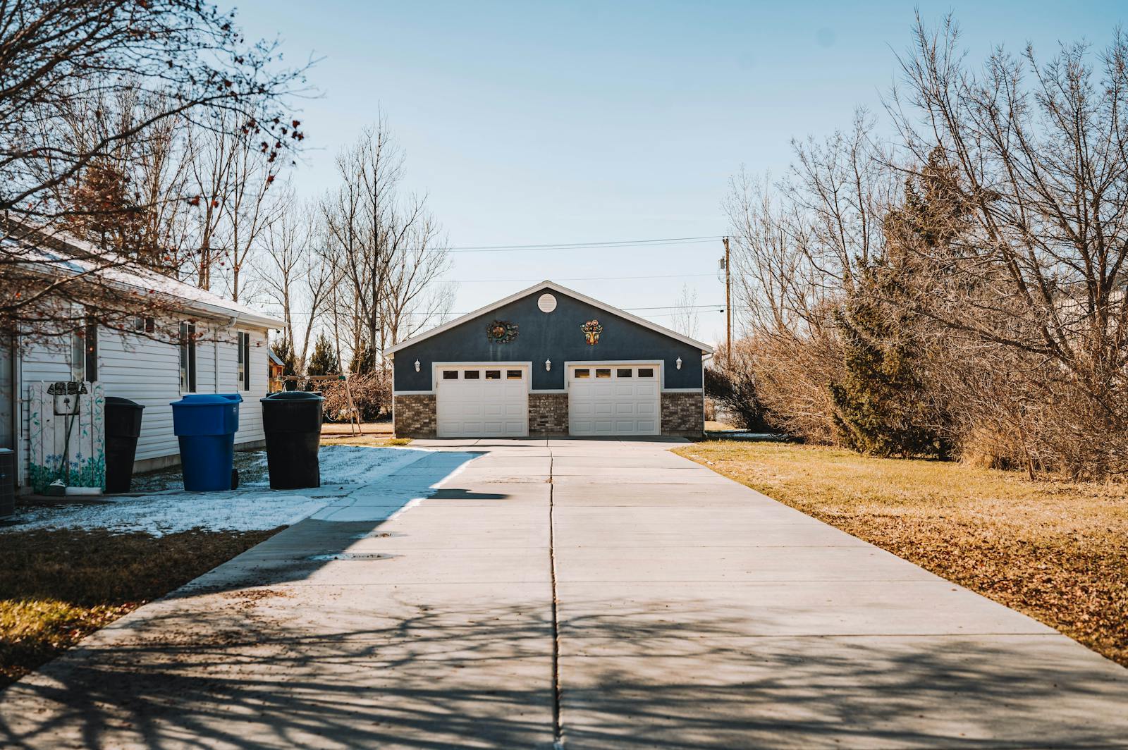 Concrete driveway leading to a two-car residential garage — typical driveway slab polyjacking restores