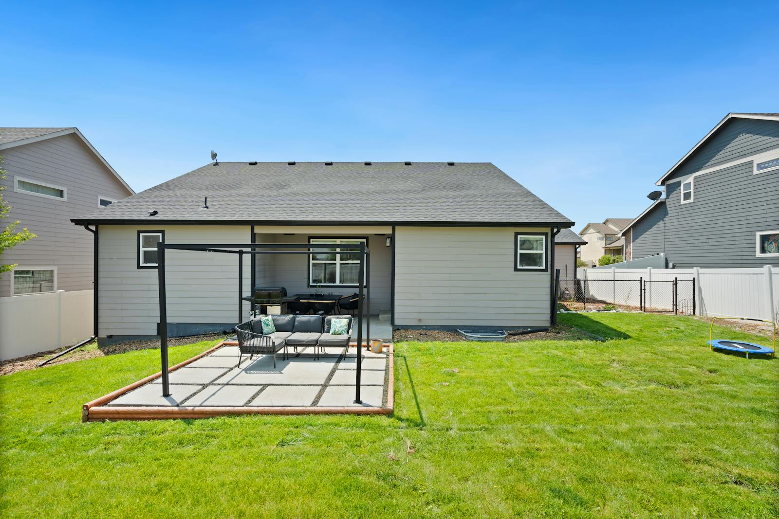 Residential home with a backyard concrete patio — typical slab work polyjacking handles