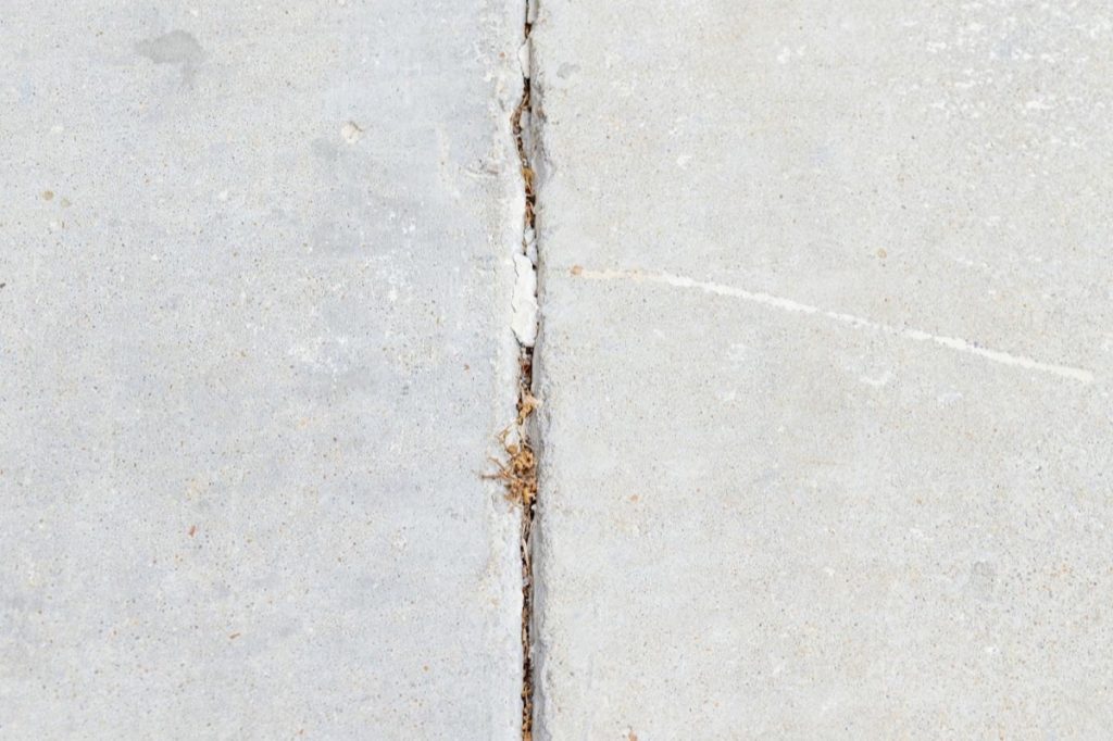 Uneven sidewalk crack repaired with concrete leveling