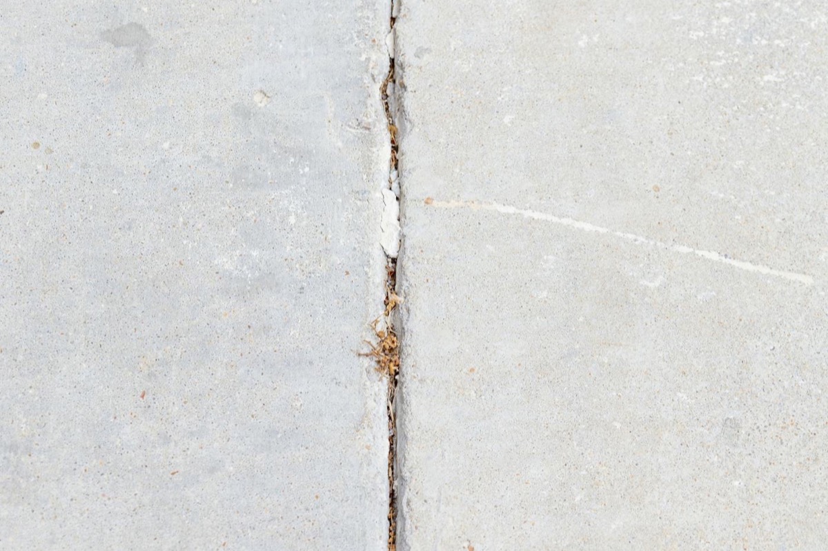 Uneven sidewalk crack repaired with concrete leveling