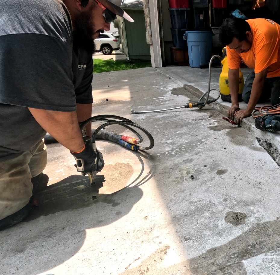 KC MudJack technician performing polyurethane concrete lifting